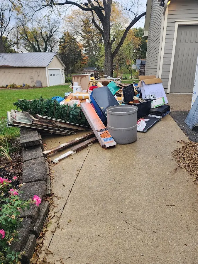 Dumpster being loaded with debris for Estate Cleanout Dumpster Rental in Cape Girardeau